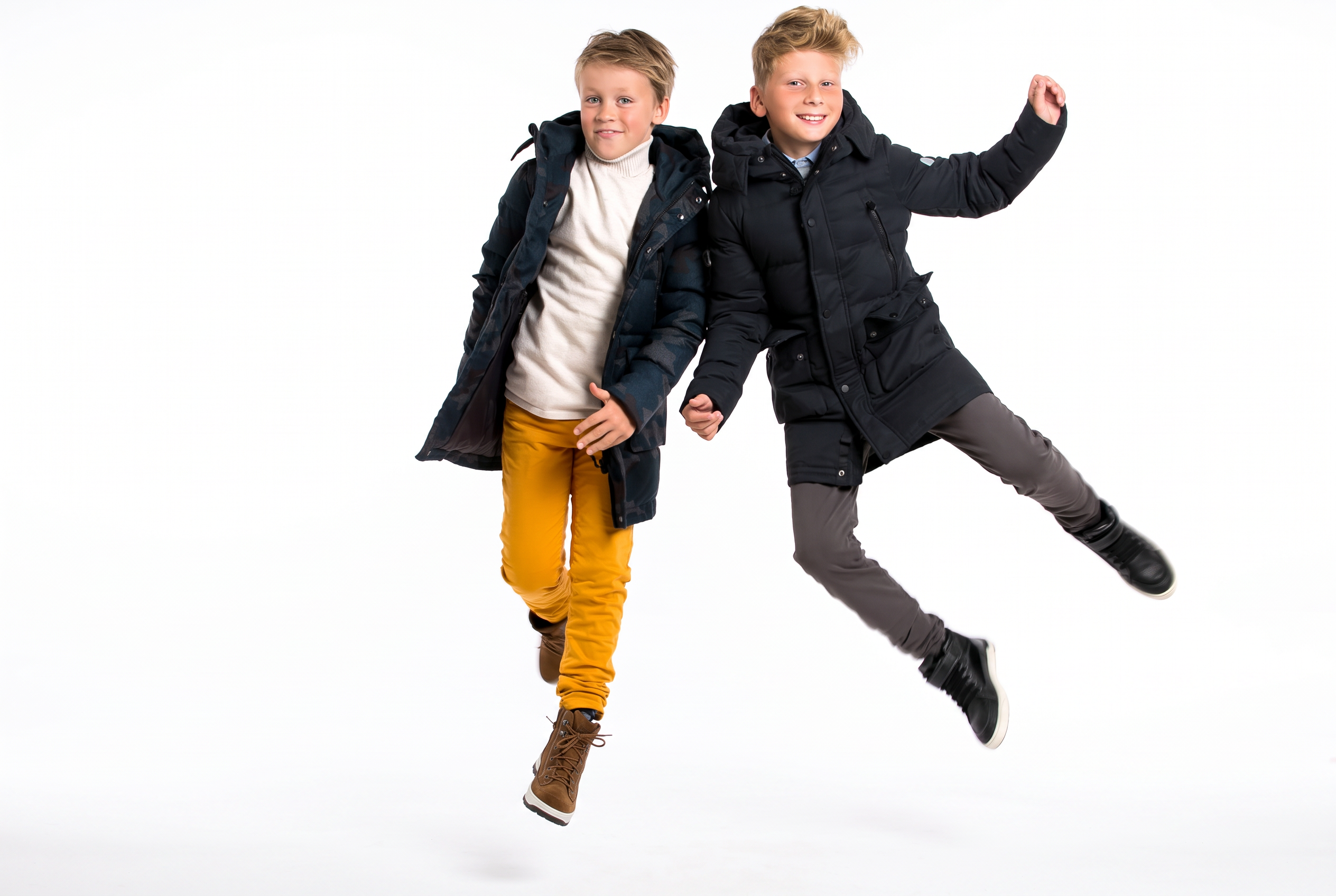 Two boys jumping in Pengu KIDS winter parkas